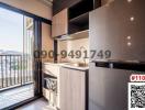 Modern kitchen with stainless steel appliances and balcony access