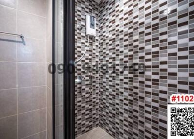 Modern tiled bathroom with glass shower cabin