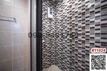 Modern tiled bathroom with glass shower cabin