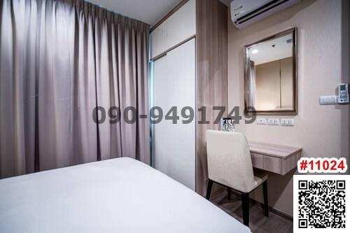 Modern bedroom interior with neutral tones, air conditioning unit and large mirror