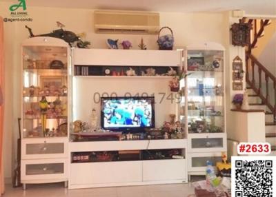 Cozy living room with entertainment unit and decorative shelving