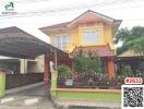 Yellow two-story house with carport and fence