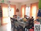 Bright dining room with large window and table set for a meal