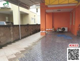 Spacious outdoor patio area with tiled flooring and bright orange walls