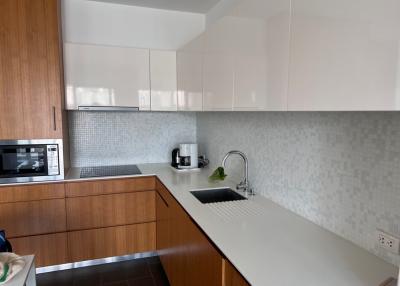 Modern kitchen with wooden cabinets and white countertops