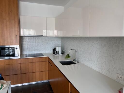 Modern kitchen with wooden cabinets and white countertops