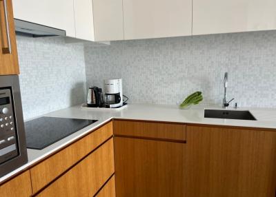 Modern kitchen with stainless steel appliances and wooden cabinets