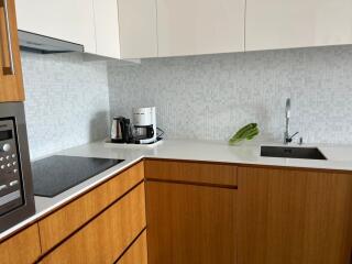 Modern kitchen with stainless steel appliances and wooden cabinets