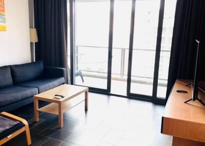 Bright living room with large windows and balcony access