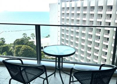 Ocean view from an apartment balcony with seating arrangement