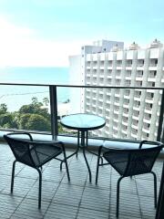 Ocean view from an apartment balcony with seating arrangement