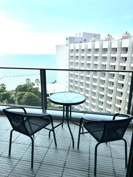 Ocean view from an apartment balcony with seating arrangement