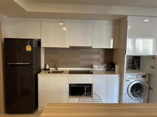 Modern kitchen with stainless steel appliances and white cabinetry