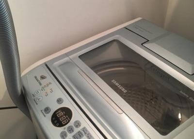 Modern laundry machine with electronic control panel in a home laundry room