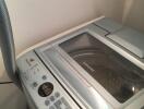 Modern laundry machine with electronic control panel in a home laundry room