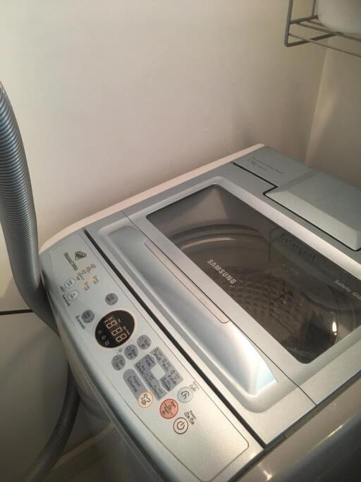 Modern laundry machine with electronic control panel in a home laundry room