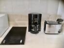 Modern kitchen appliances including a coffee maker and toaster on a counter