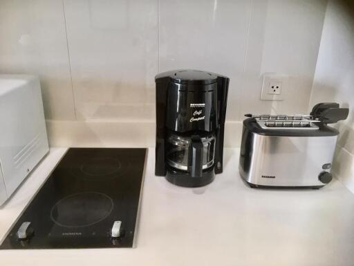 Modern kitchen appliances including a coffee maker and toaster on a counter