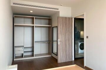 Spacious bedroom with built-in wardrobe and access to laundry room