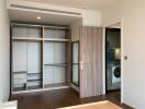 Spacious bedroom with built-in wardrobe and access to laundry room