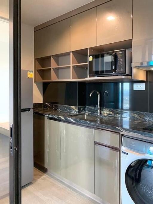 Modern kitchen with stainless steel appliances and dark cabinets