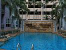 Swimming pool area with waterfall feature in a residential building complex