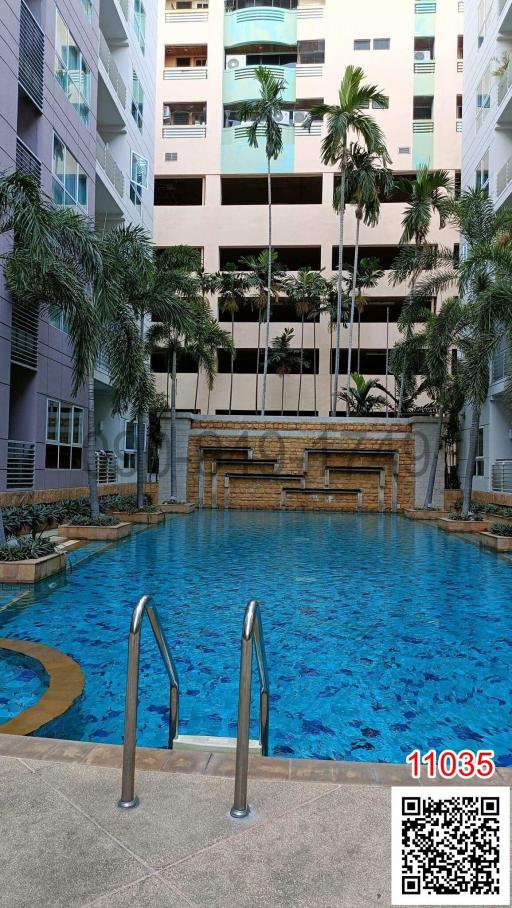 Swimming pool area with waterfall feature in a residential building complex