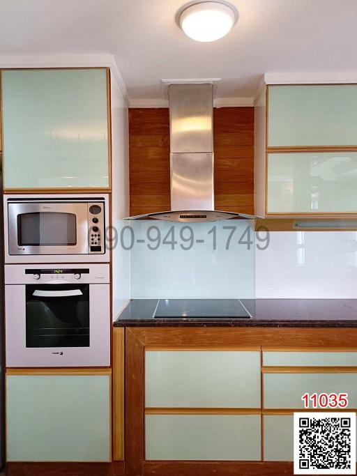 Modern kitchen with stainless steel appliances and wooden cabinets