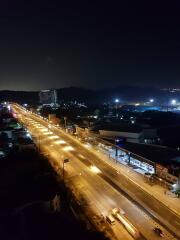 Nighttime city view from a high vantage point overlooking a busy street