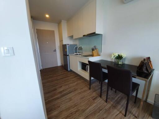 Modern kitchen with dining area and wooden flooring