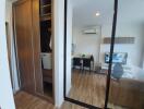 Cozy bedroom with mirror sliding wardrobe doors, reflecting an open living space