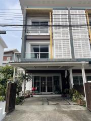 Modern townhouse exterior with balcony and garage