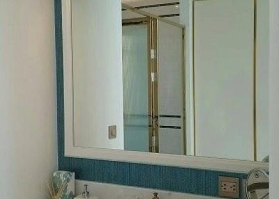 Modern bathroom interior with well-lit vanity mirror and sink