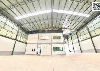 Spacious industrial warehouse interior with office space