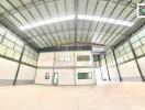 Spacious industrial warehouse interior with office space
