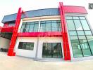 Modern two-story building with red accents and large glass windows