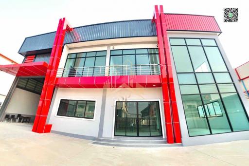 Modern two-story building with red accents and large glass windows