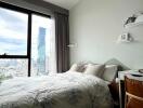 Modern bedroom with a city view through a large window