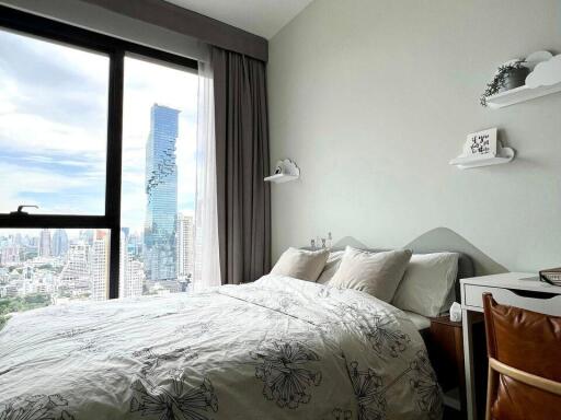 Modern bedroom with a city view through a large window