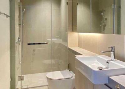 Modern bathroom interior with glass shower and white fixtures