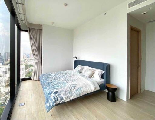 Modern bedroom with large windows and cityscape view