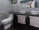 Modern bathroom with dual vessel sinks and mosaic tile walls