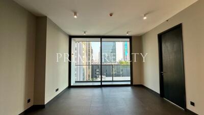 Spacious unfurnished apartment interior with large windows and city view