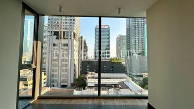 Spacious room with large windows offering a cityscape view