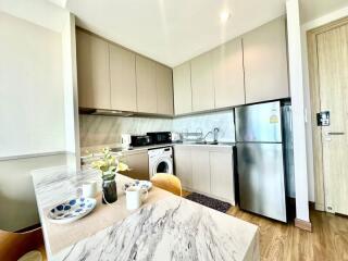 Modern kitchen with stainless steel appliances and marble countertop