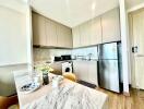 Modern kitchen with stainless steel appliances and marble countertop