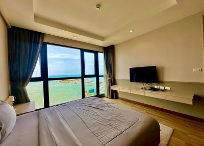 Modern bedroom with a sea view and large windows