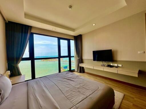 Modern bedroom with a sea view and large windows