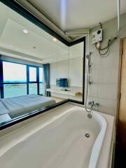 Spacious bathroom with large bathtub and modern amenities overlooking the ocean