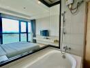 Spacious bathroom with large bathtub and modern amenities overlooking the ocean